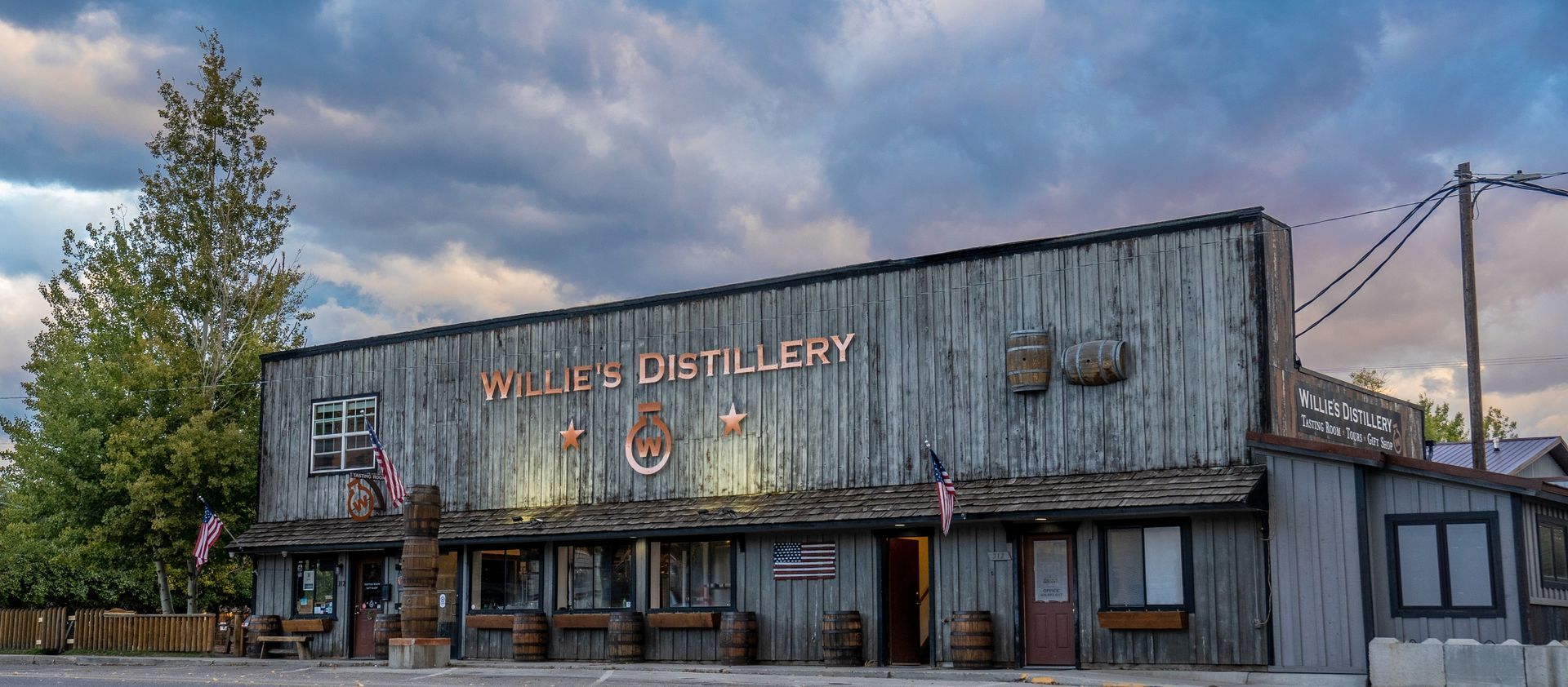 A large wooden building with the word distillery on it.