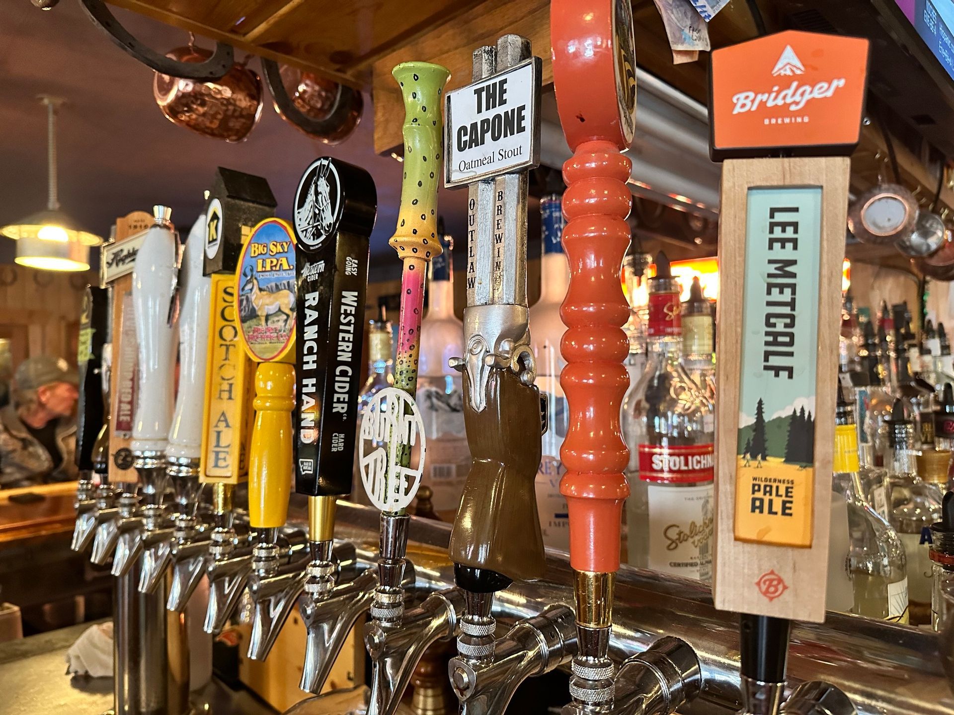 A bar with many beer taps including lee metcalf