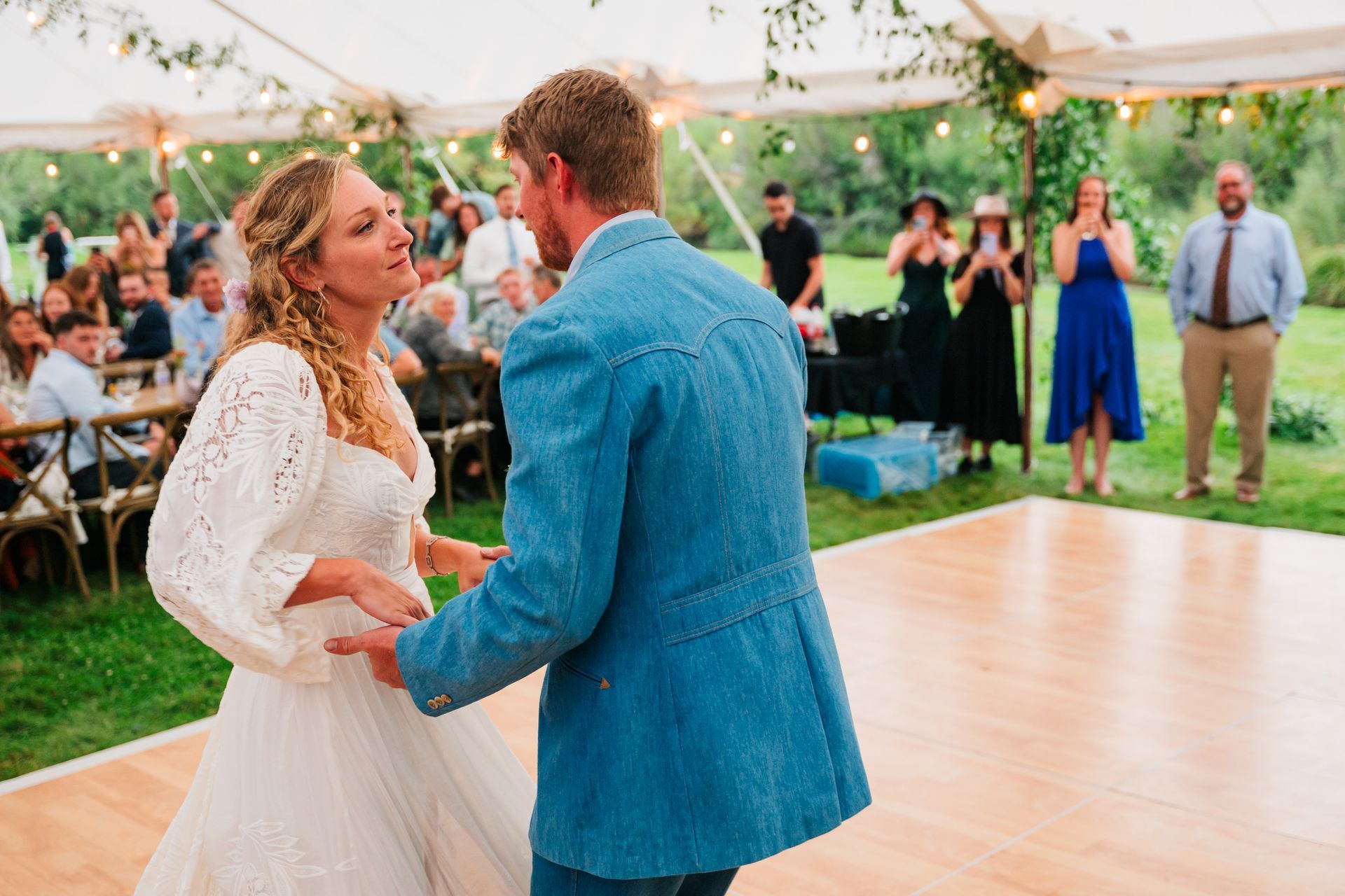 Bride and groom dancing in outdoor venue