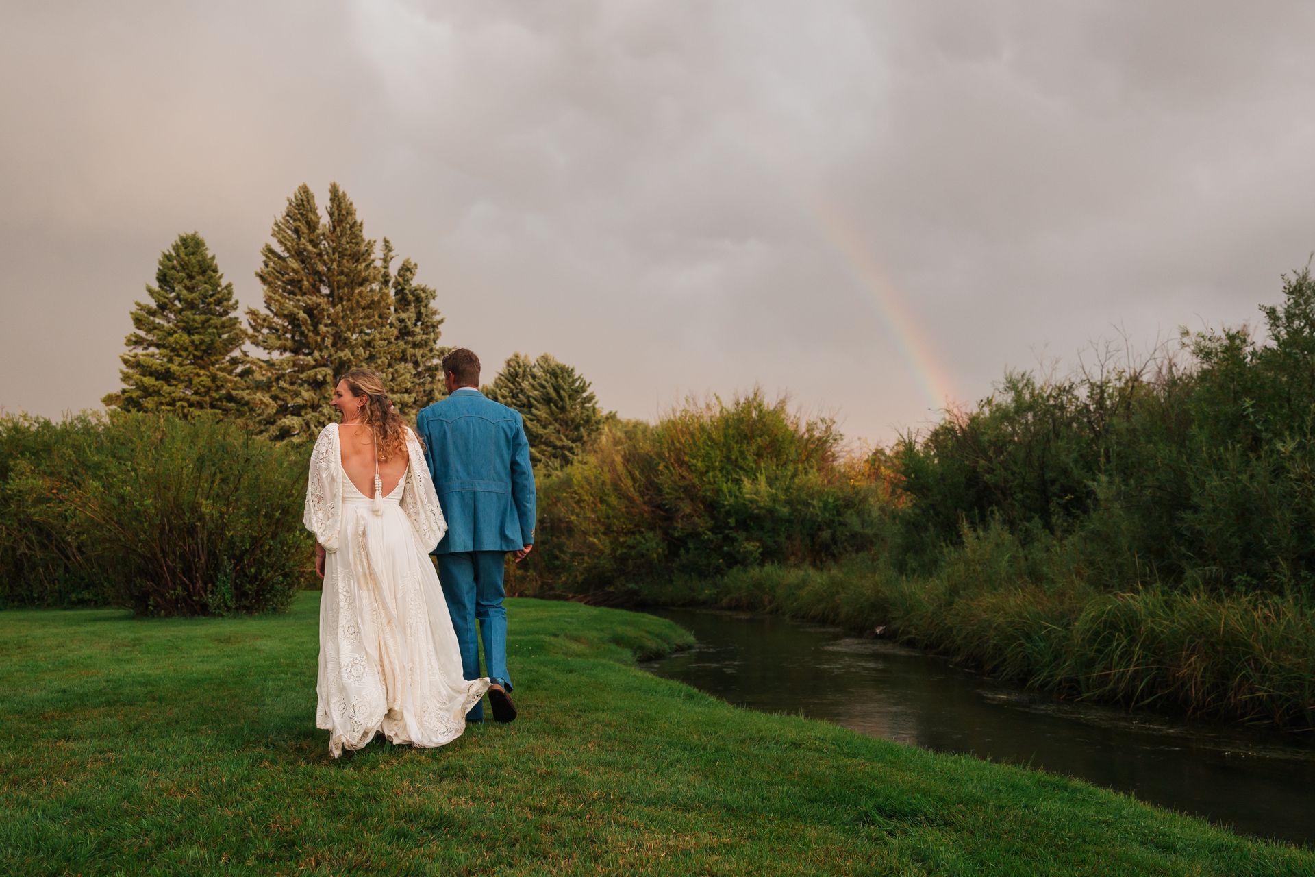 bride and groom with rainbow background
