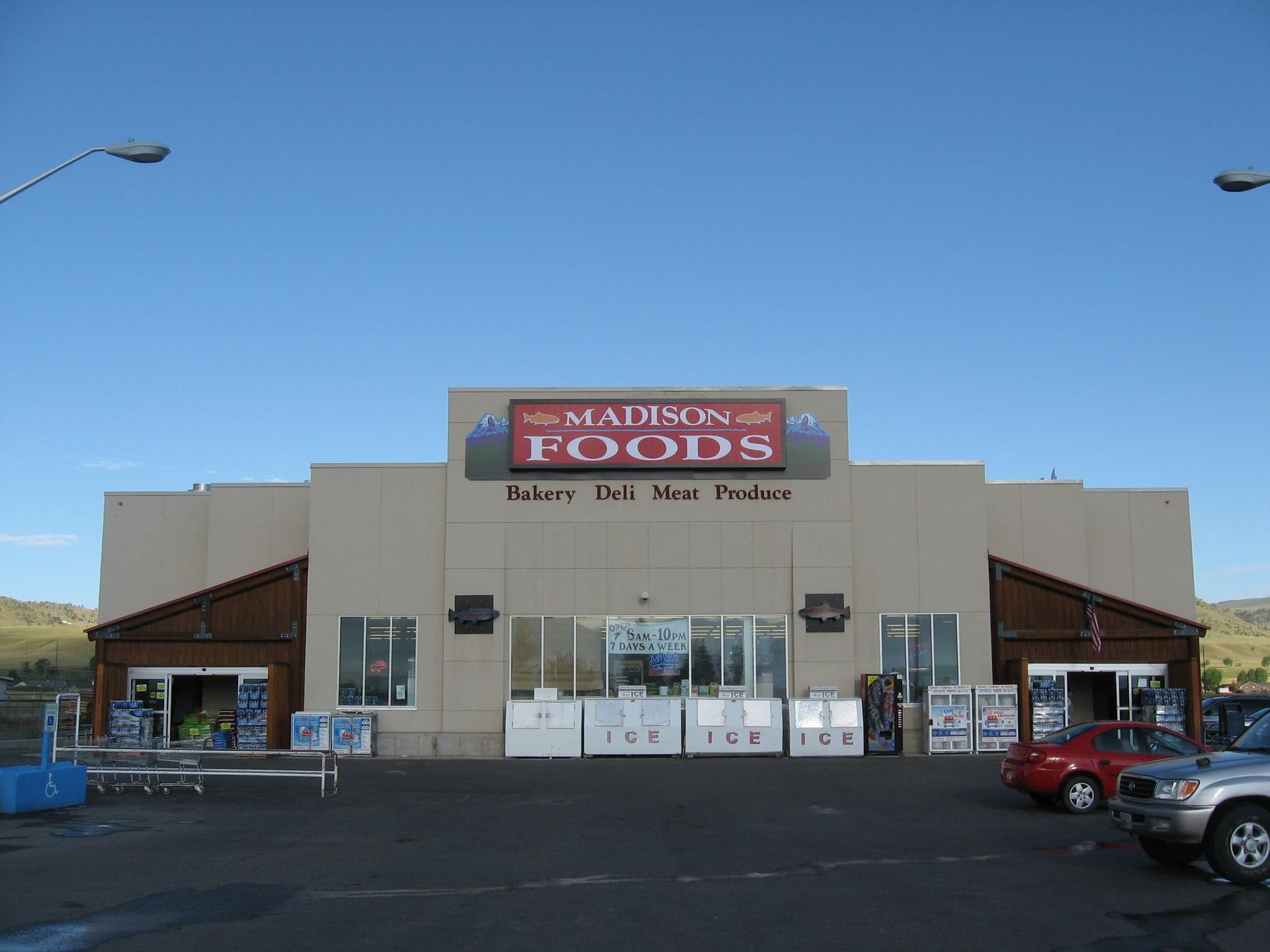 A madison foods store with cars parked in front of it