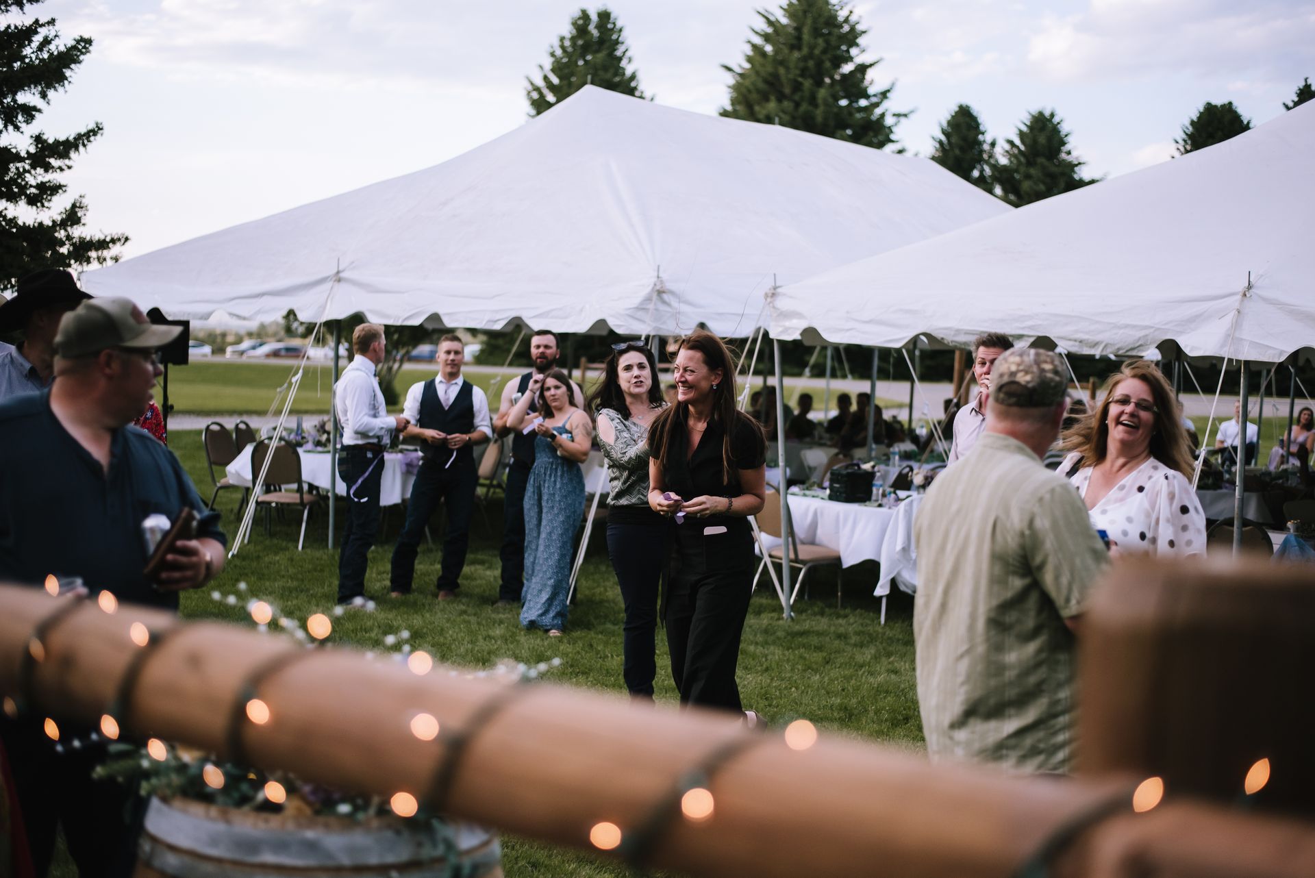 Outdoor wedding reception with tent and guests