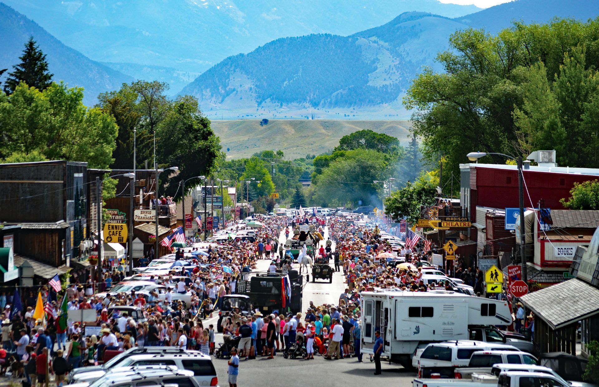 A crowded street with mountains in the background