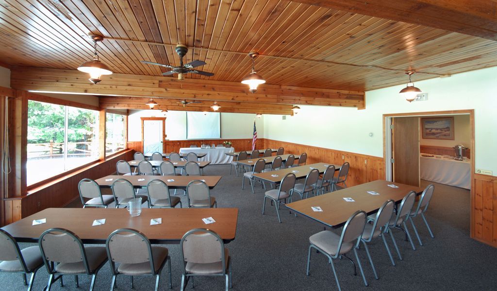 A large room with tables and chairs in it