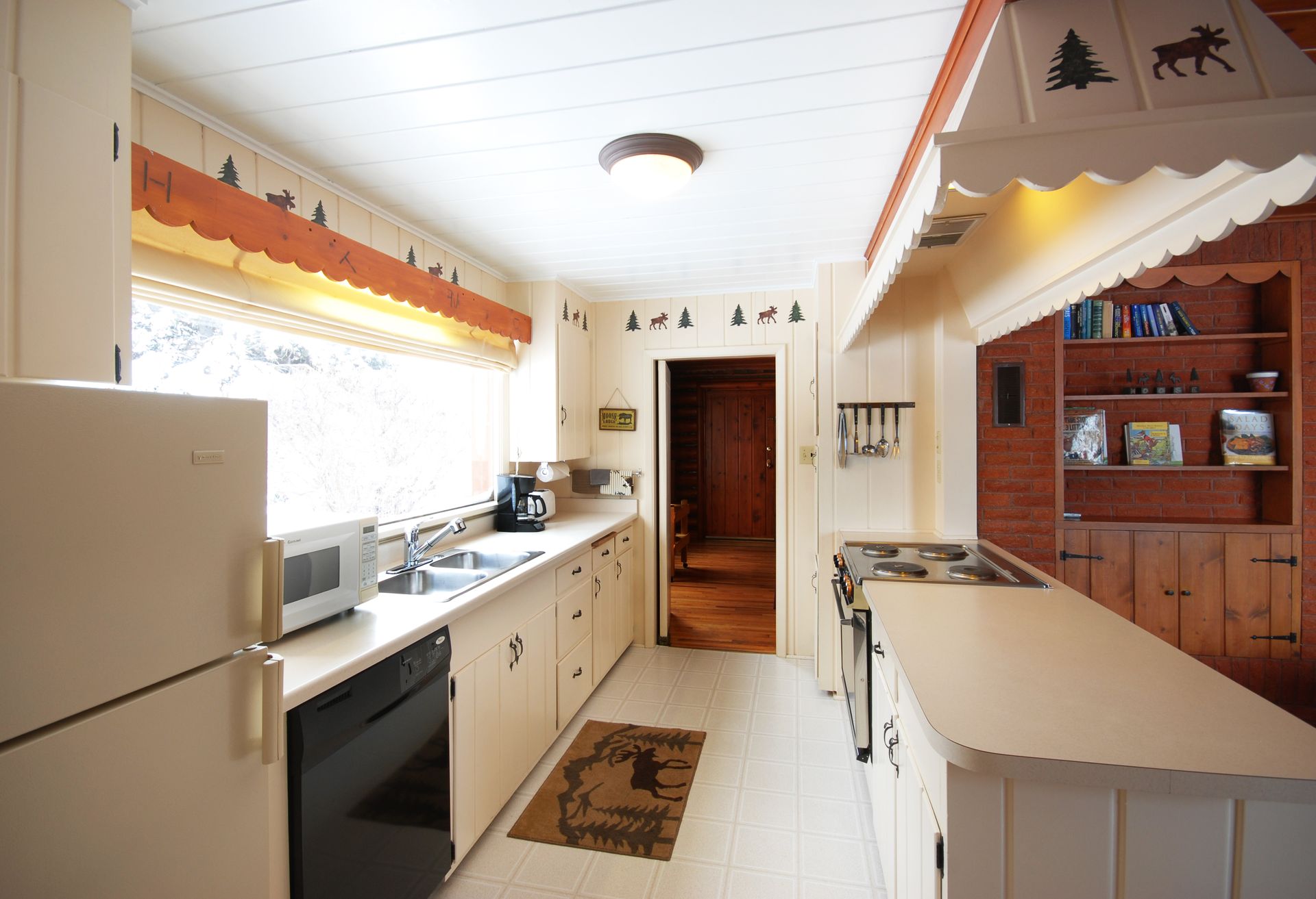 A kitchen with white cabinets and a refrigerator