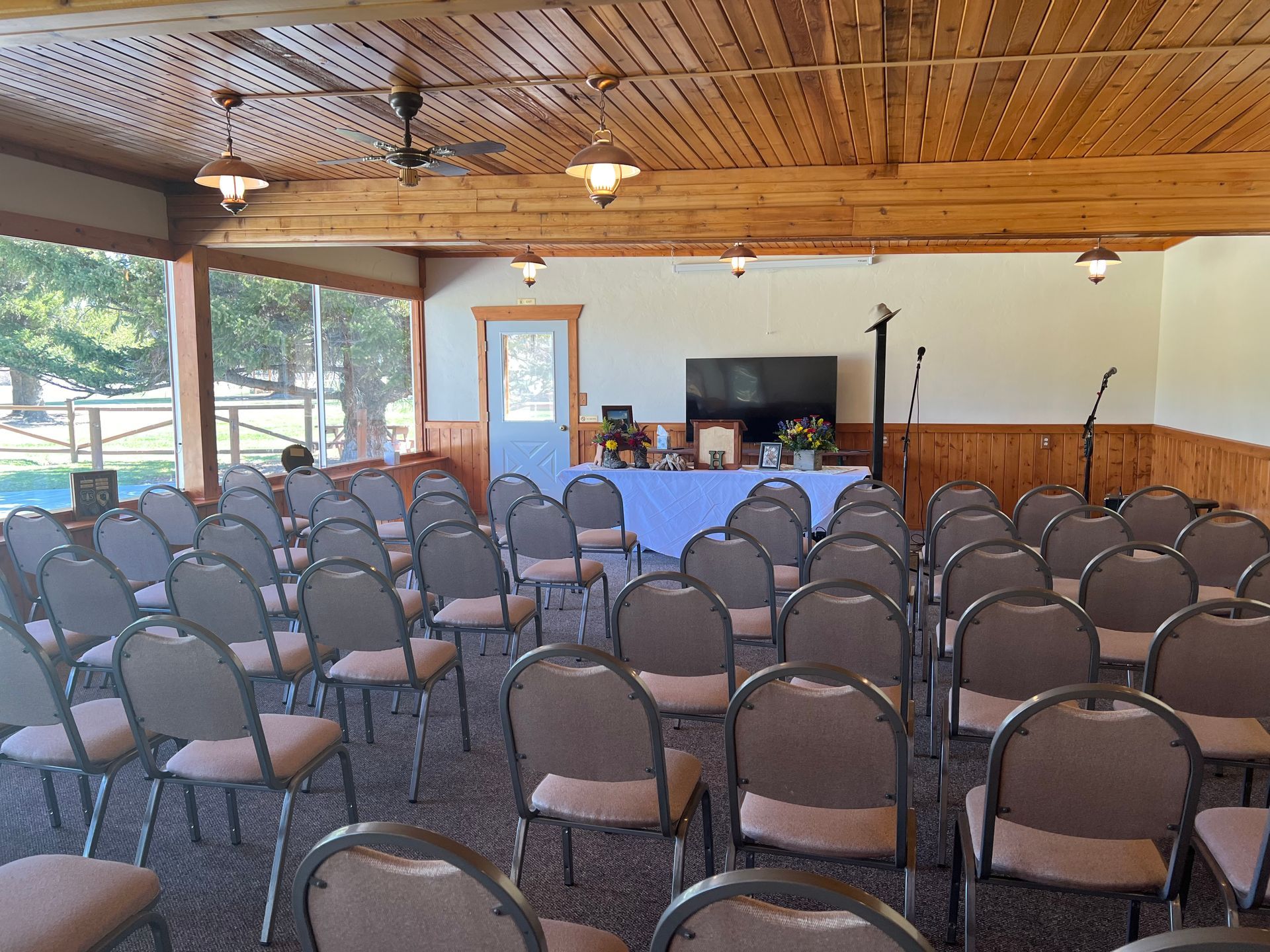 A room filled with rows of chairs and a table.