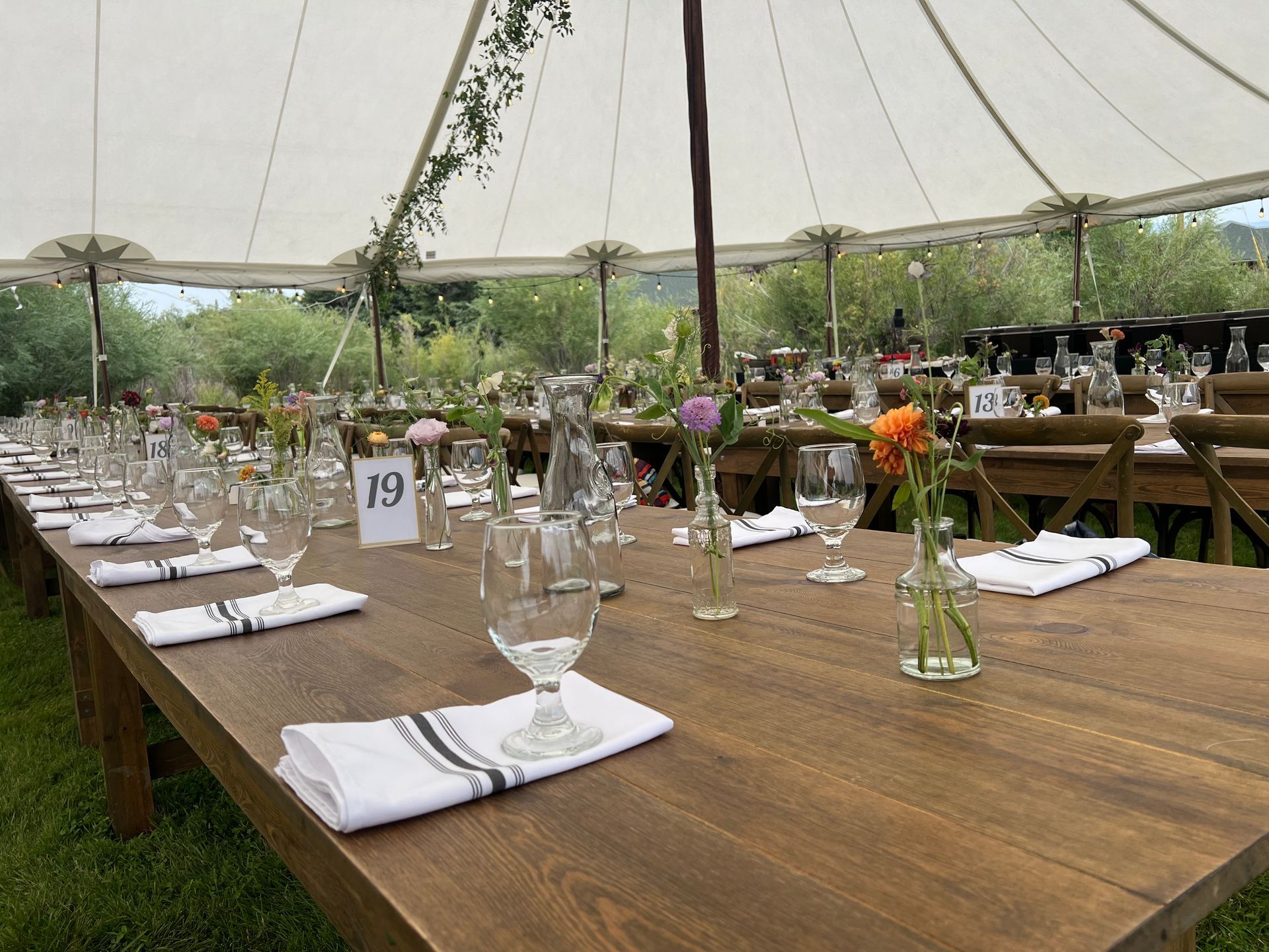 Outdoor venue with tent and dinner setting