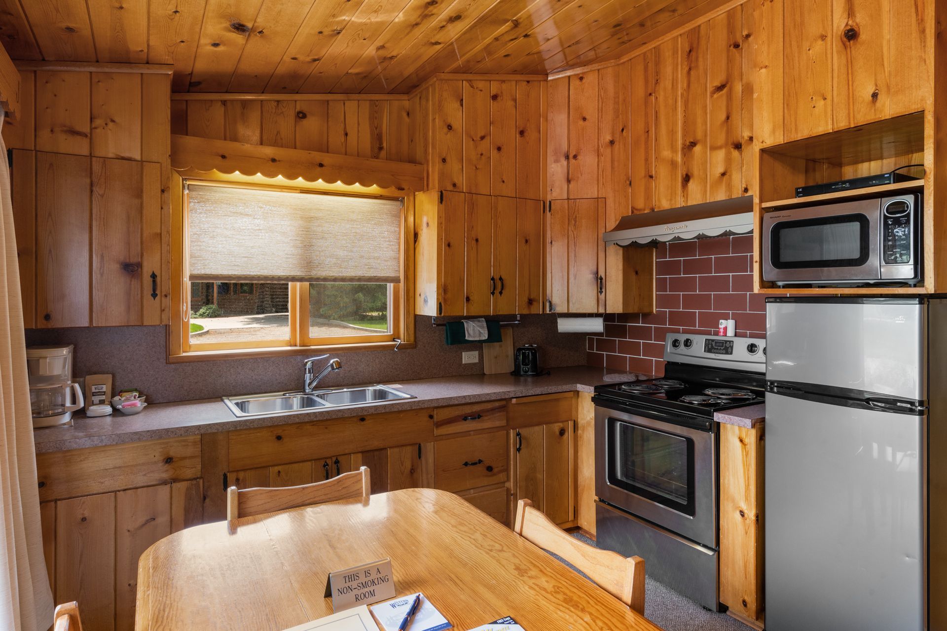 A kitchen with wooden cabinets and stainless steel appliances