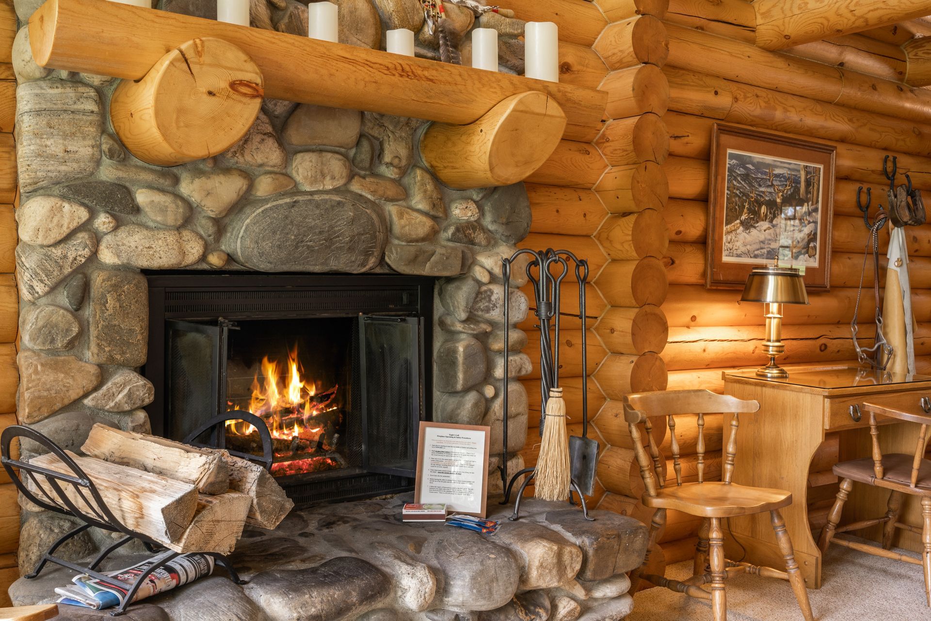 A log cabin with a fireplace and a desk