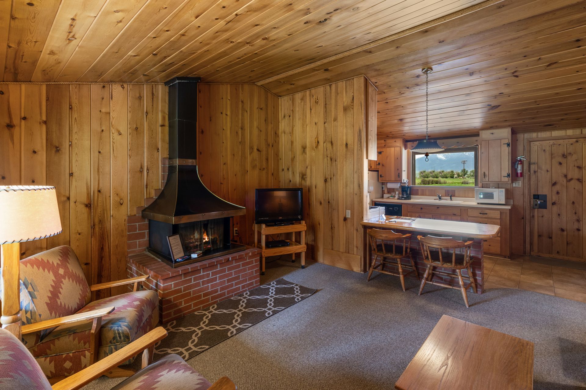 A living room with a fireplace and a television