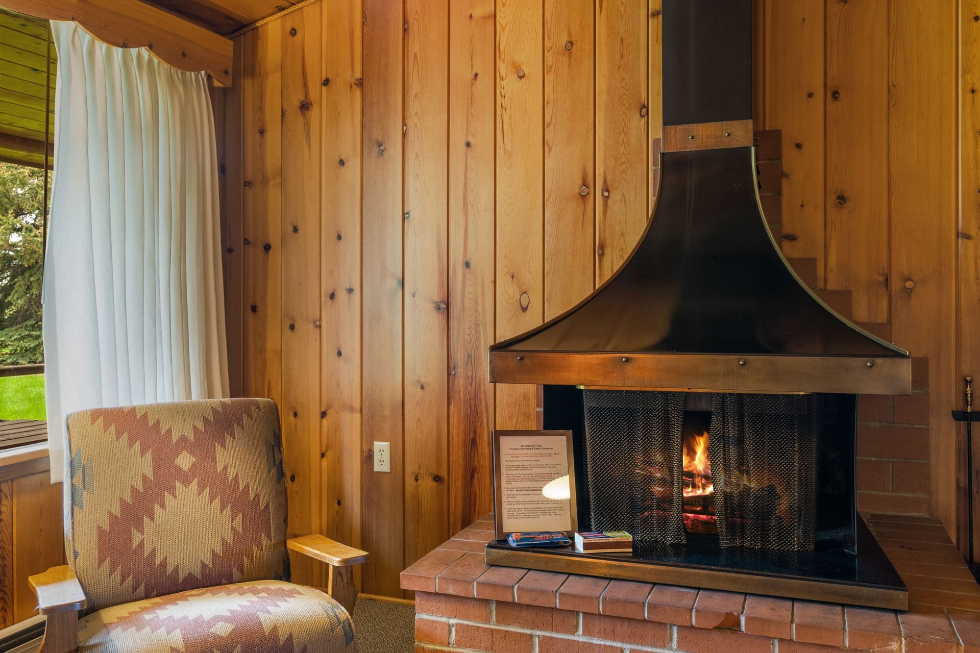 A living room with a fireplace and a chair