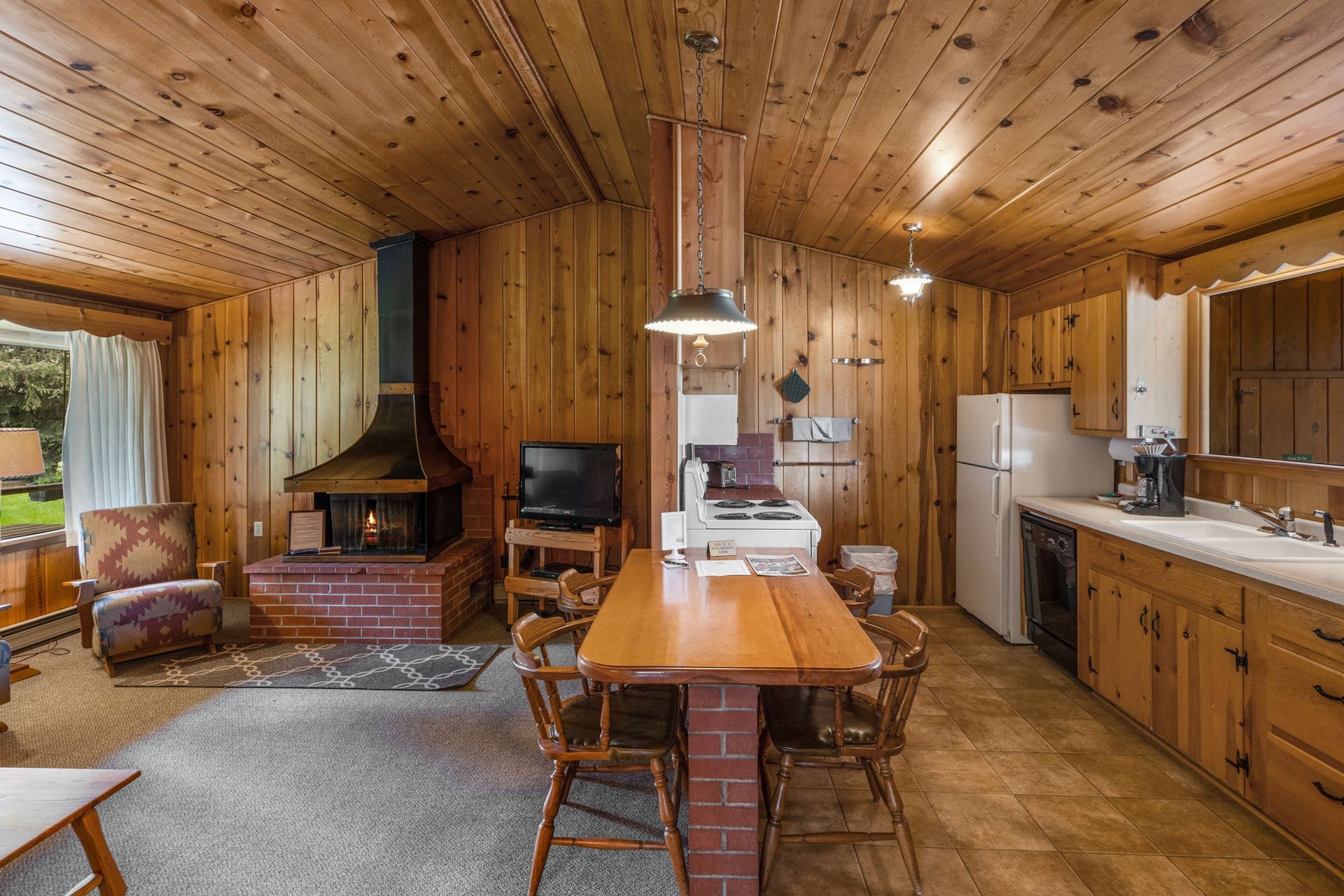 There is a table and chairs in the middle of the room.