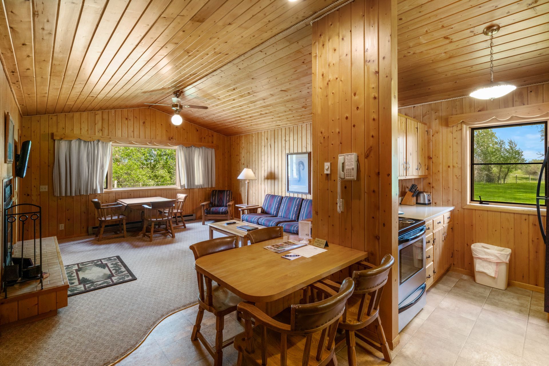 There is a table and chairs in the middle of the room.