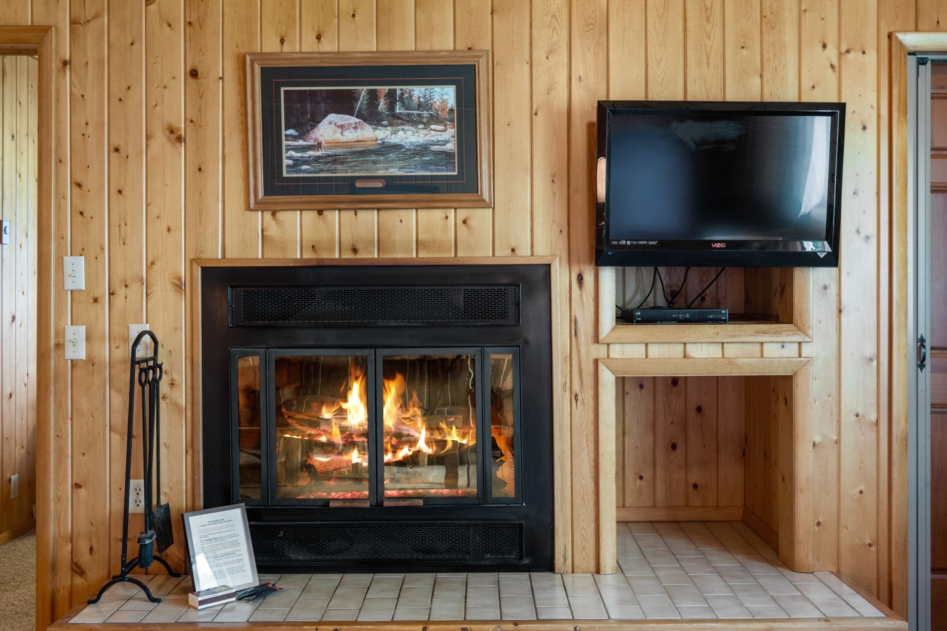 A living room with a fireplace and a flat screen tv