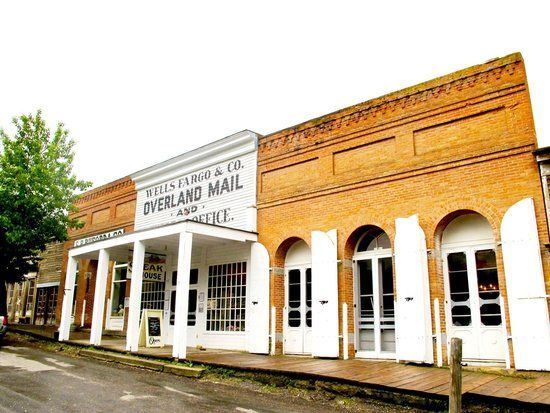 A brick building with a white sign that says overland mail