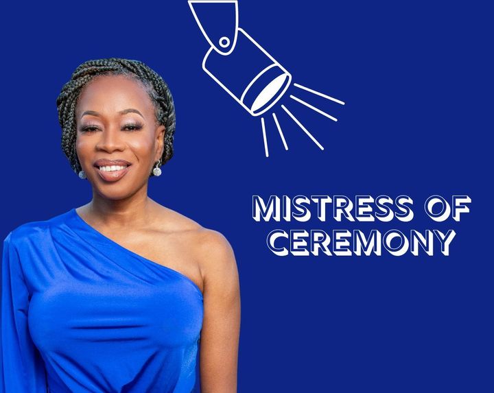 MiMi K in a blue dress is standing in front of a blue background that says mistress of ceremony