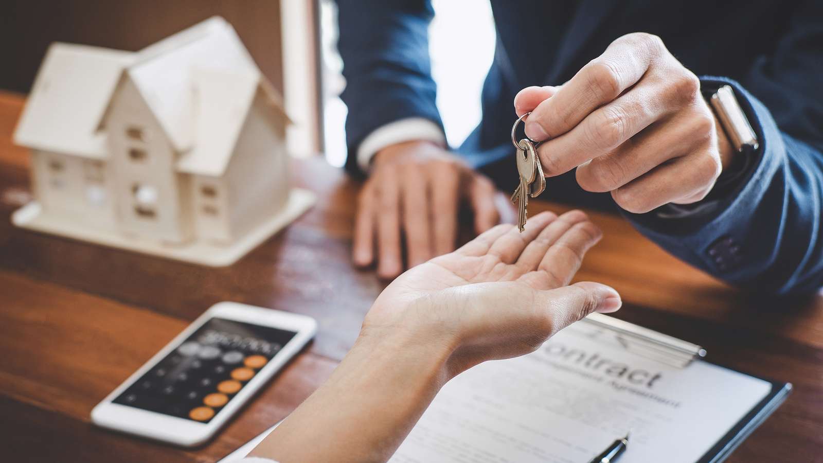 real estate agent holding a home key