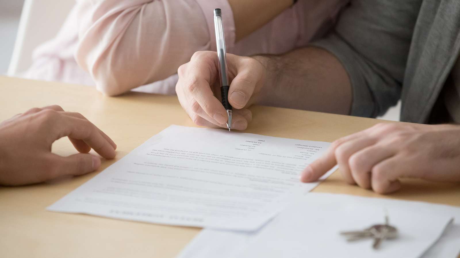 couple renters holding a pen