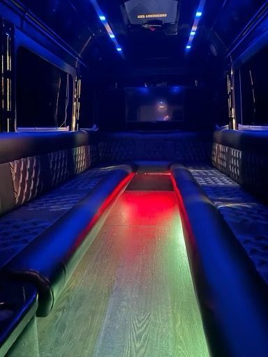 The inside of a shuttle bus with blue and green lights.