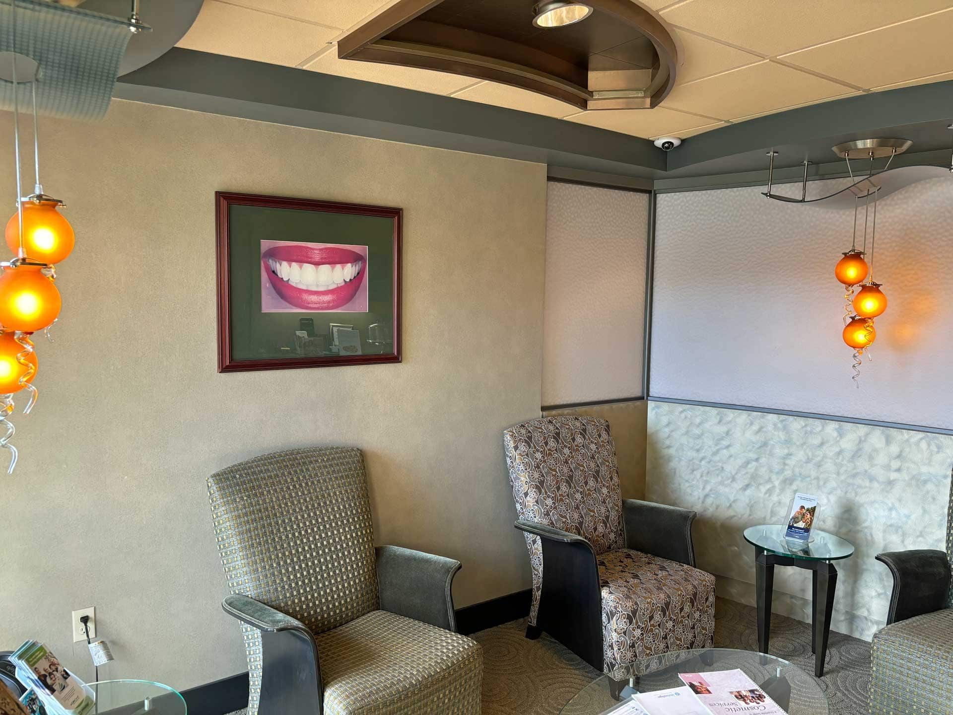 A photo of Envisia's waiting room with chairs and a picture of a smile on the wall.