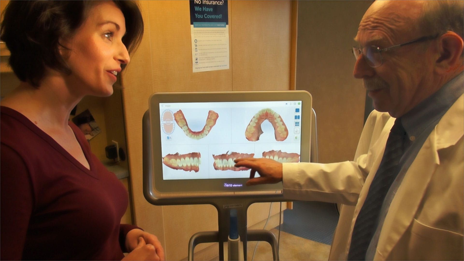 A photo of Dr. Bob and a woman are standing in front of a computer screen.