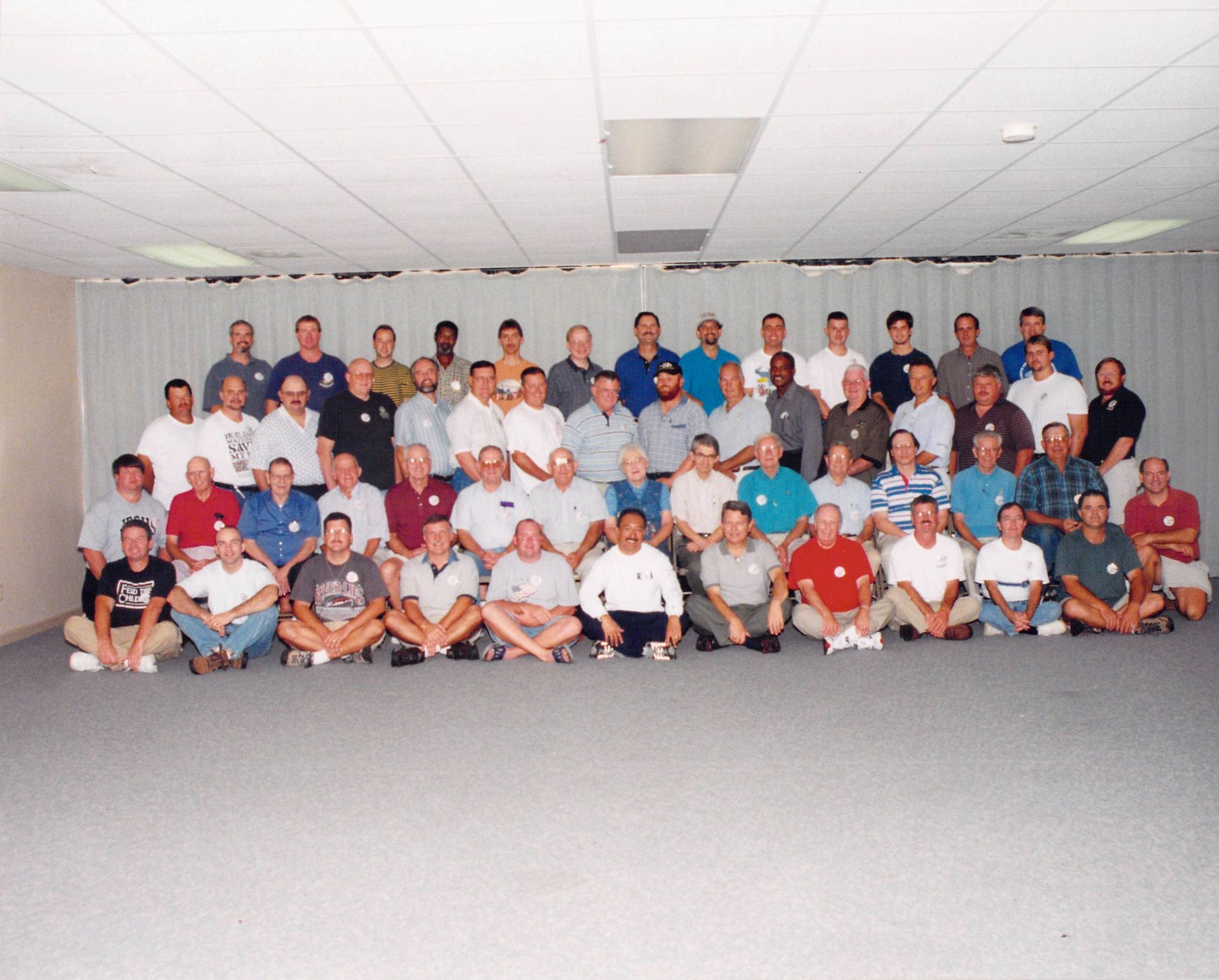A large group of men are posing for a picture