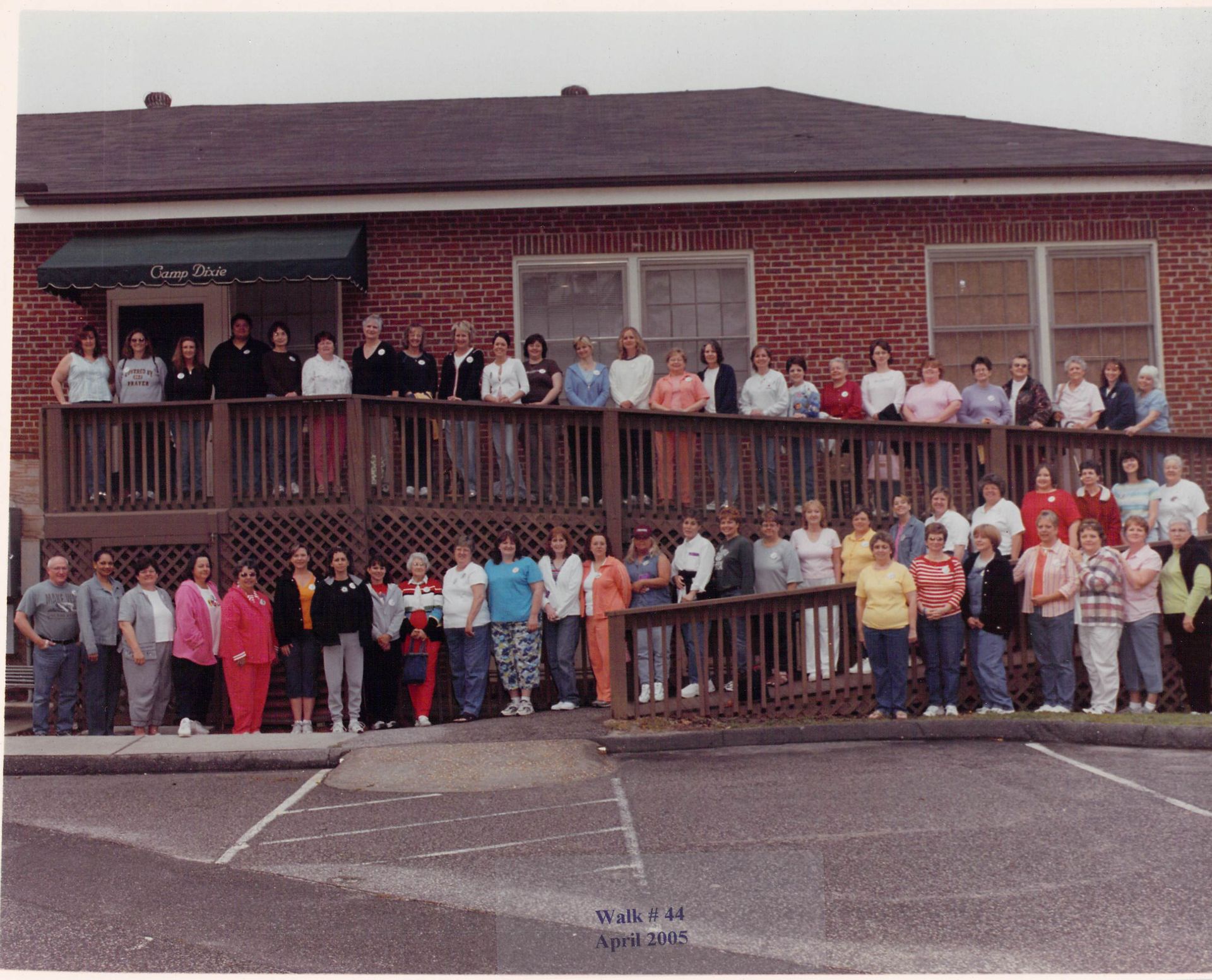 A large group of people standing in front of a brick building