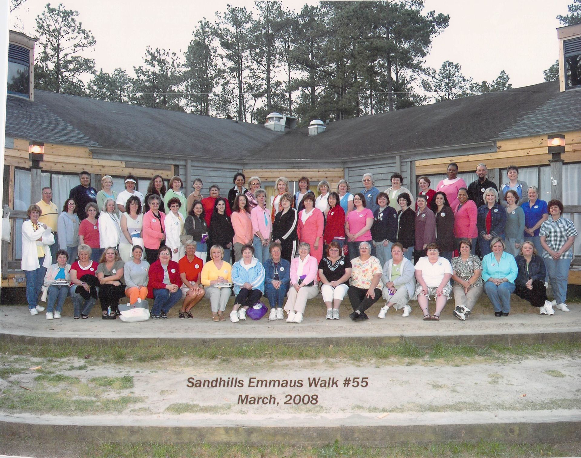 A large group of people are posing for a photo at sandhills emeritus high school