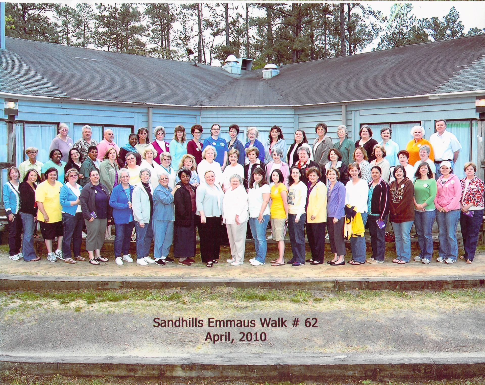 A group of people standing in front of a building with the date april 2010