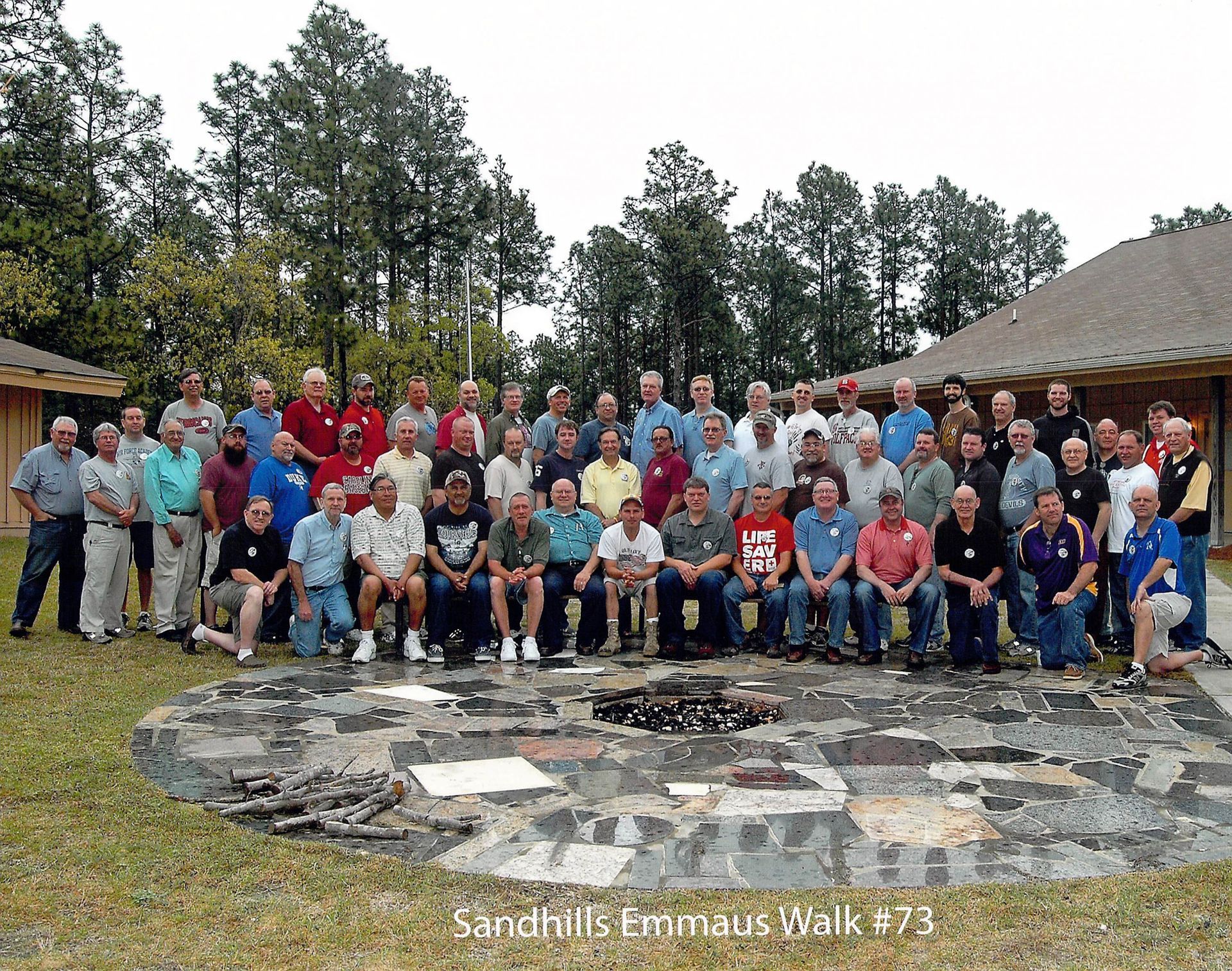 A group of men are posing for a picture with the words san falls emmaus we k273 on the bottom