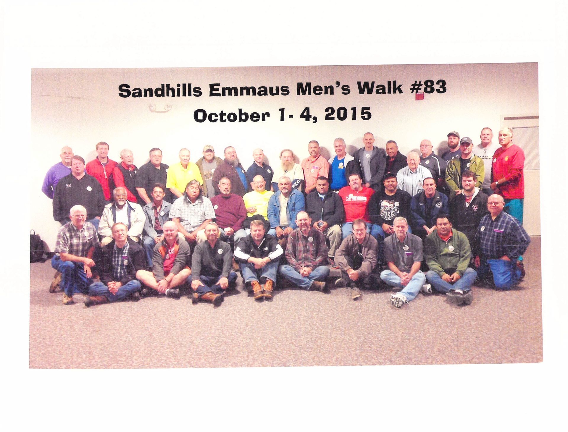 A group of men are posing for a photo at sandhills emmaus men 's walk # 63