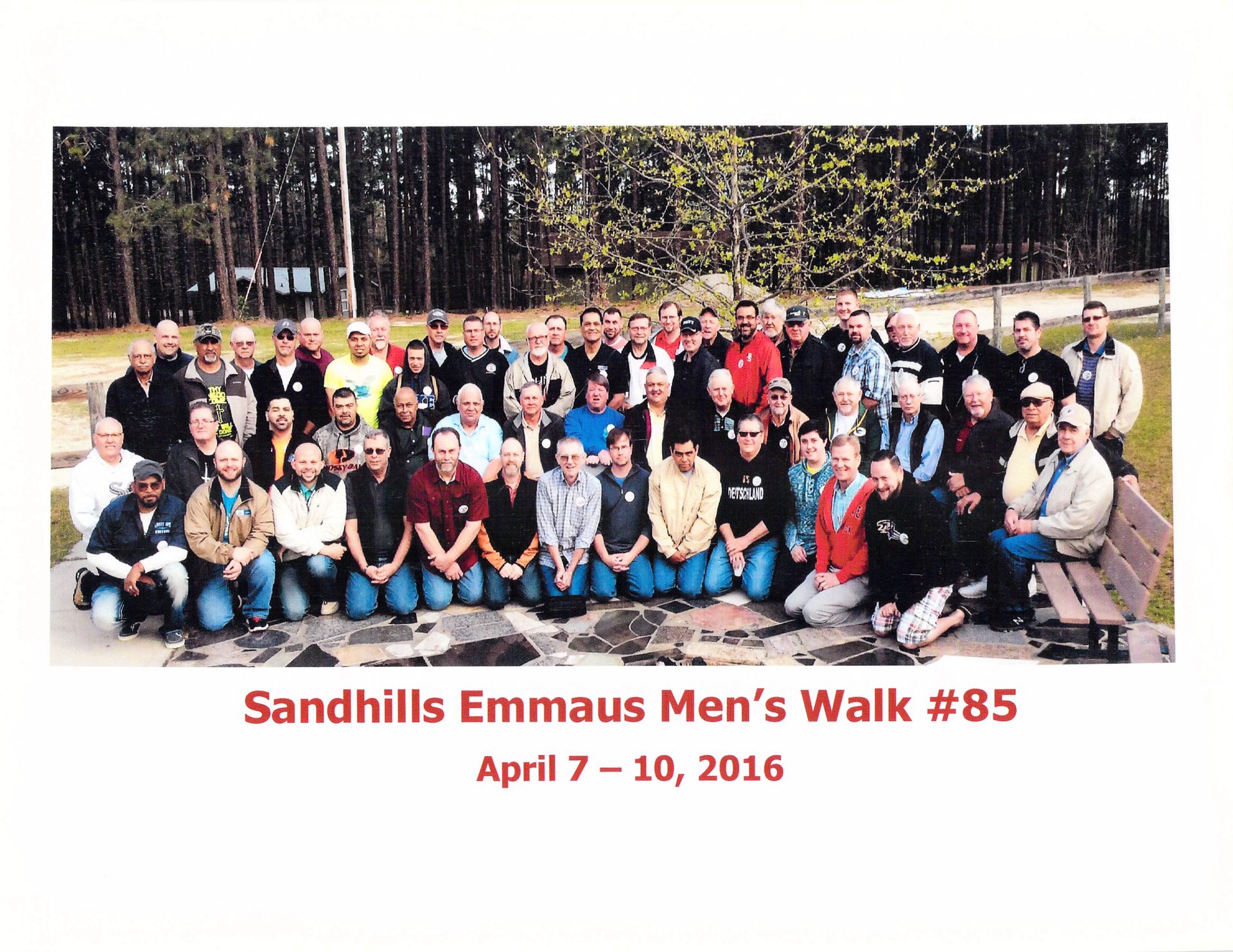 A group of people are posing for a photo at sandhills emmaus men 's walk # 85