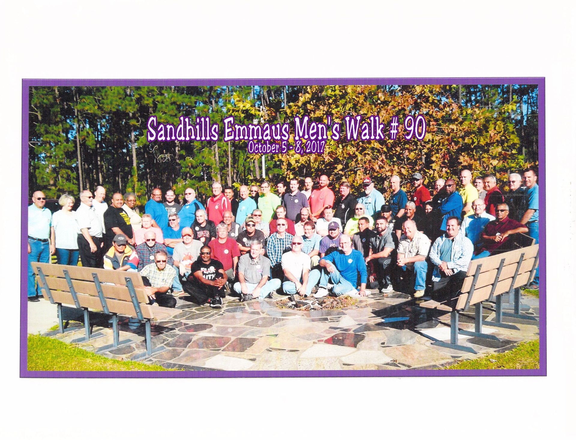 A group of people posing for a picture with the words sandhills emmanuel 's men 's walk # 90 on the bottom
