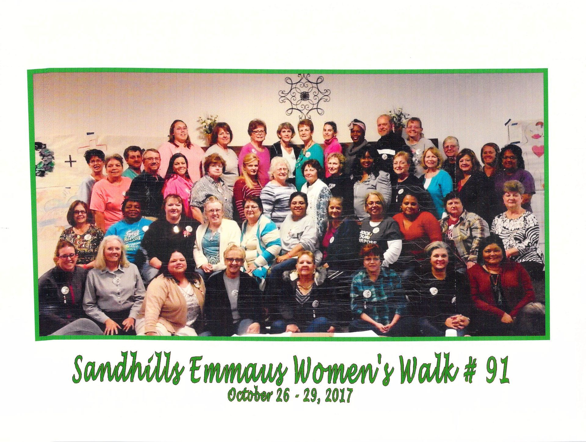 A group of people are posing for a photo at sandhills emmaus women 's walk # 91