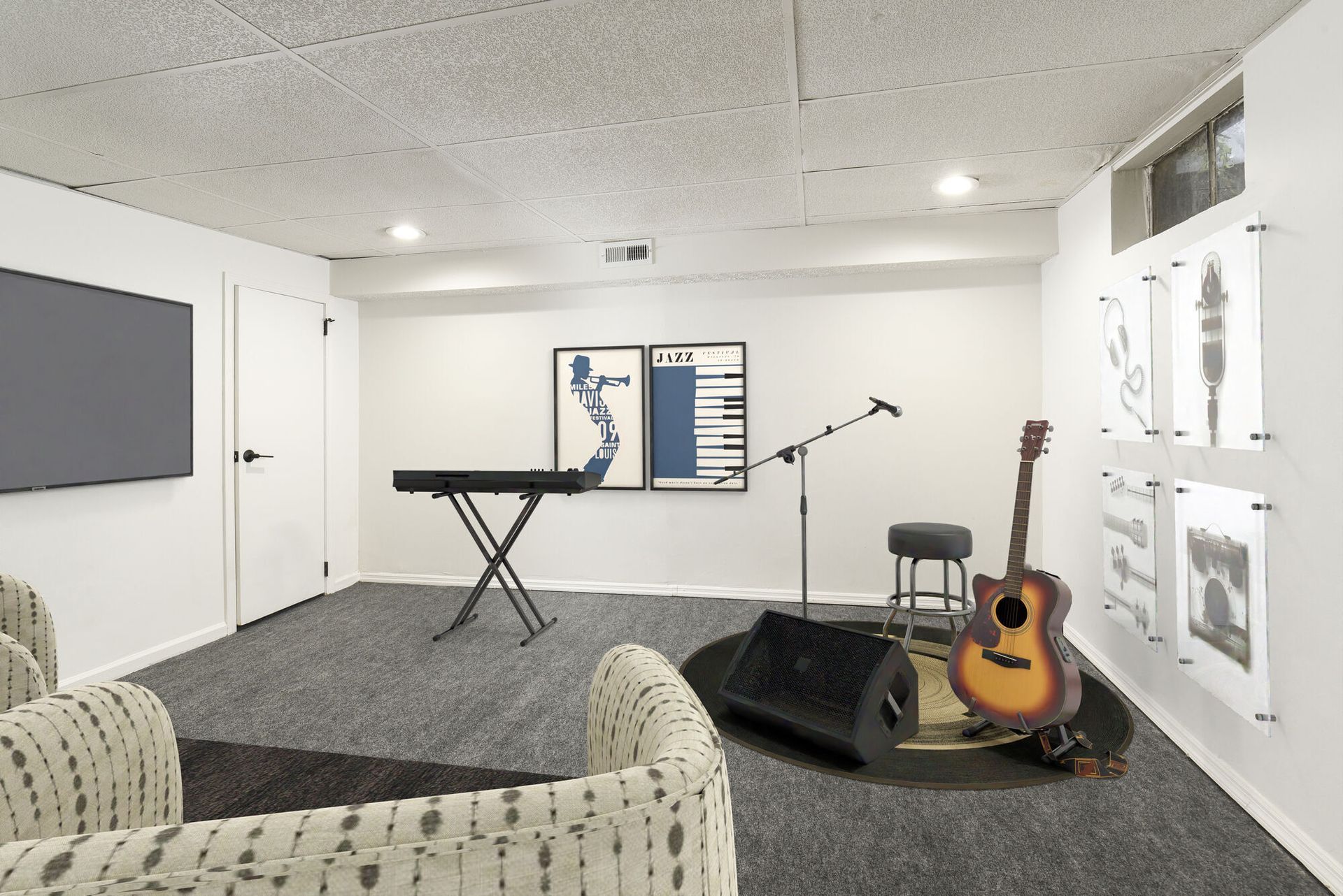 Community music room with keyboard, guitar, microphone, and seating.