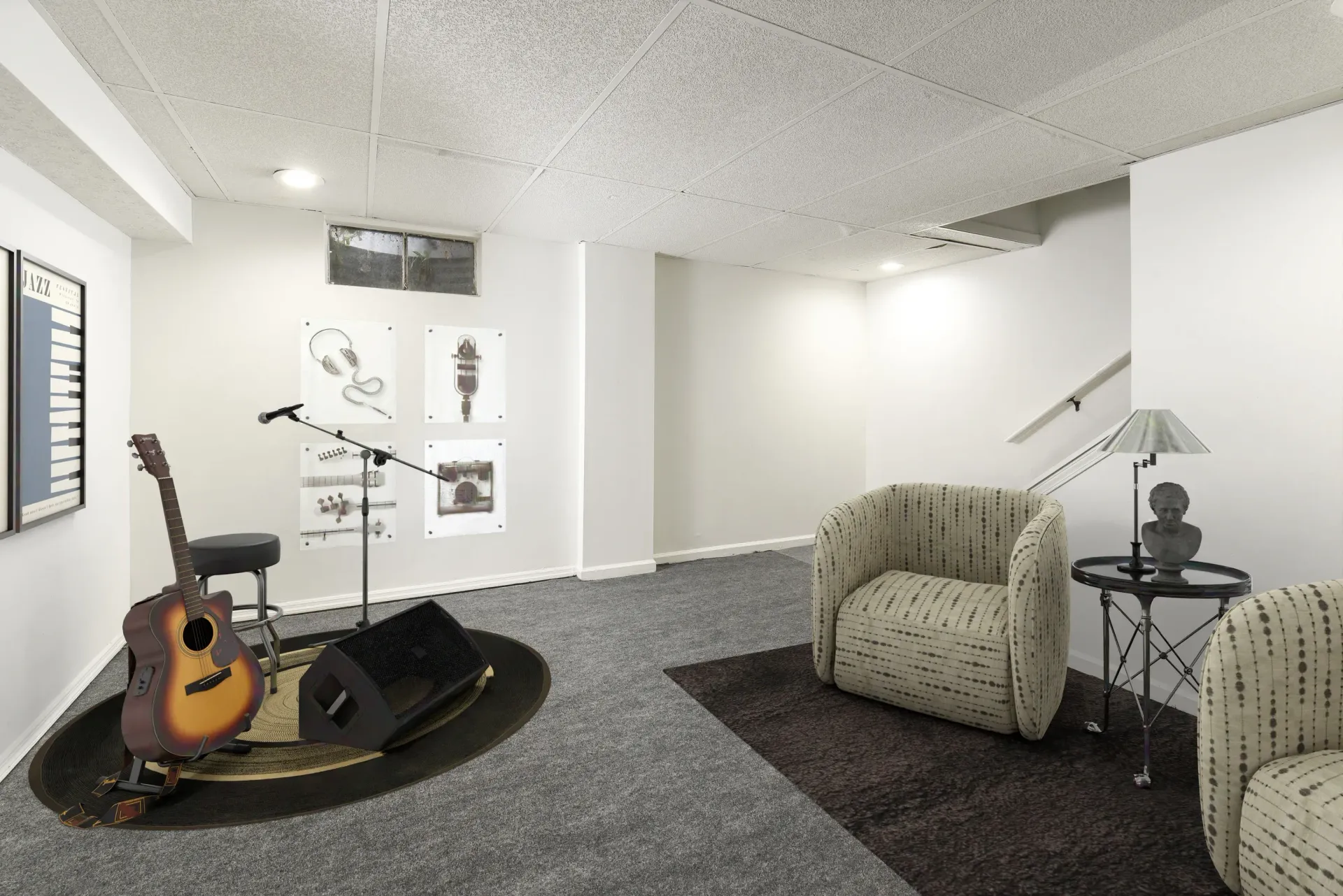 Basement music room in a community lounge with a guitar on a stand, microphone, posters, and two armchairs.