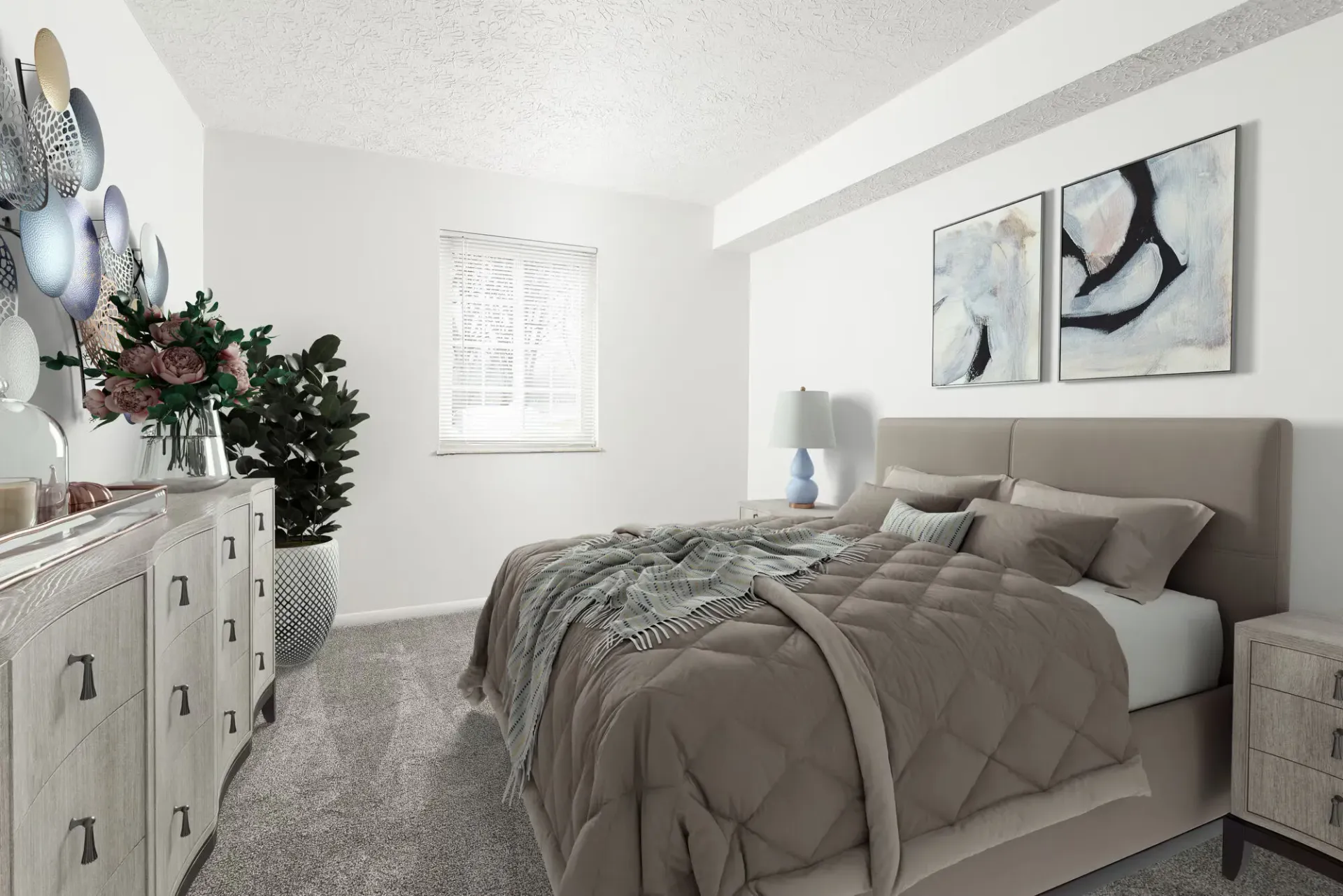 Bedroom in a modern apartment with beige bed, dressers, plants, and abstract art.