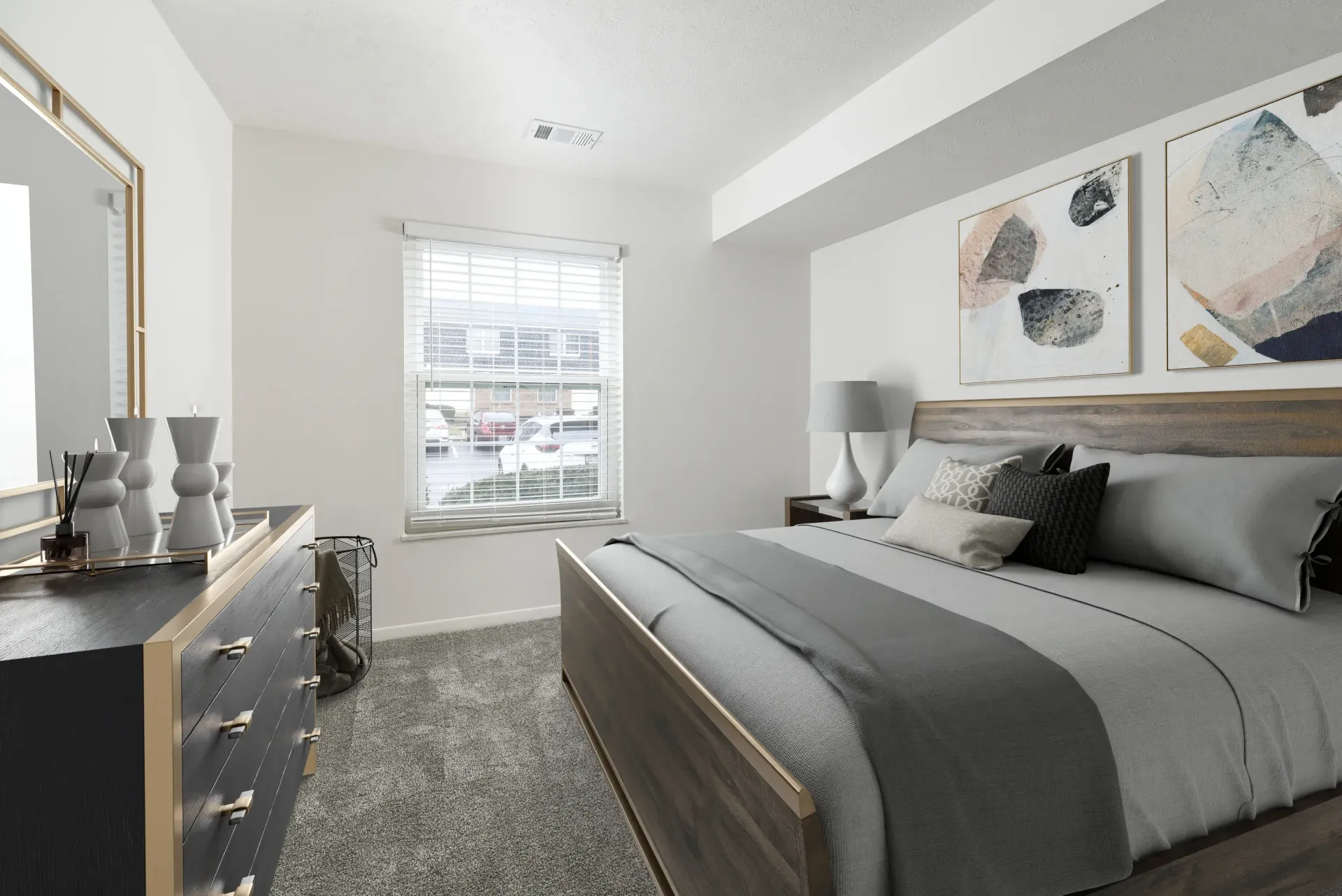 Bedroom in an apartment with a gray bed, dresser, and window blinds.