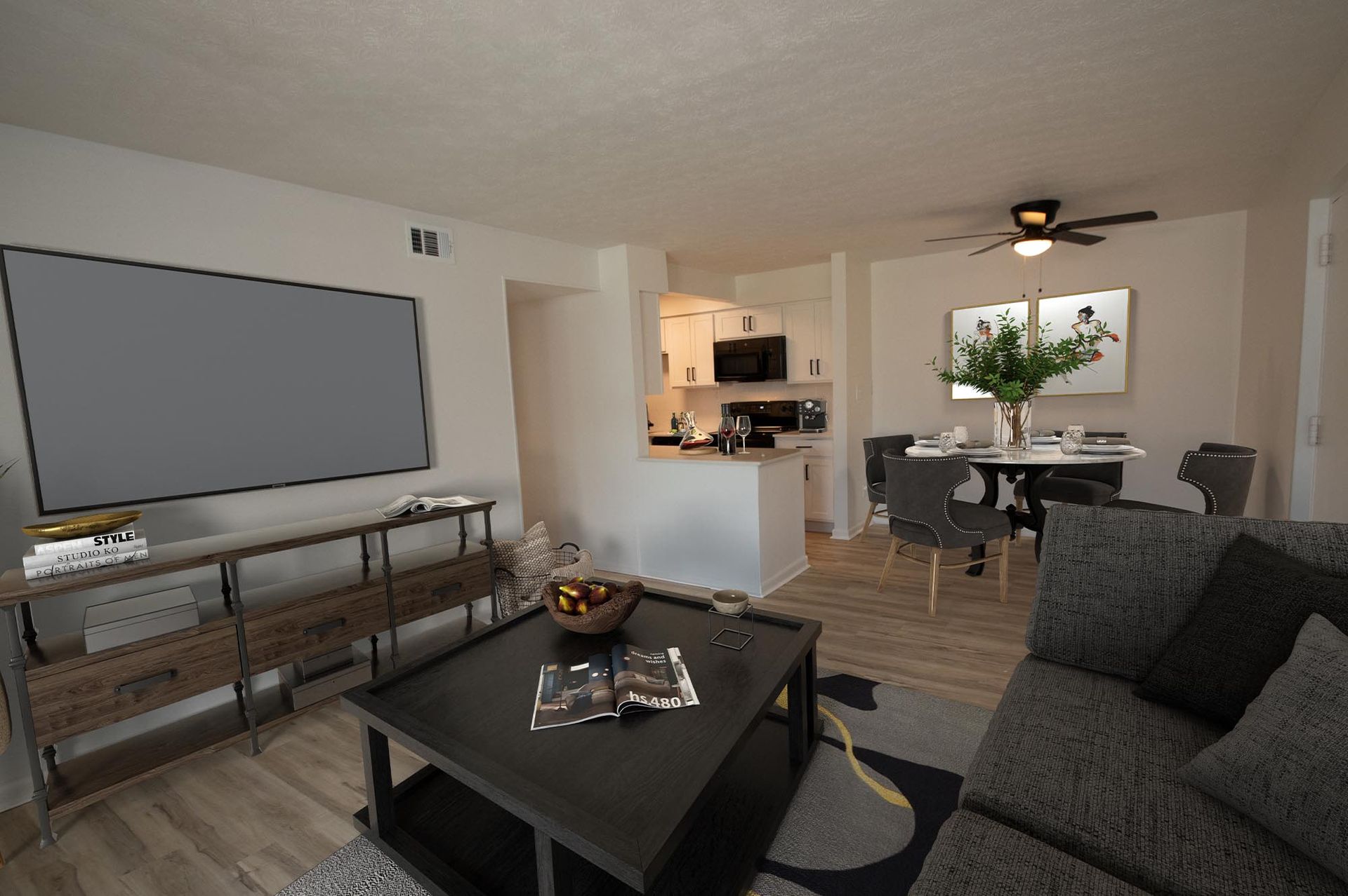 Open-concept living room and kitchen area in an apartment.