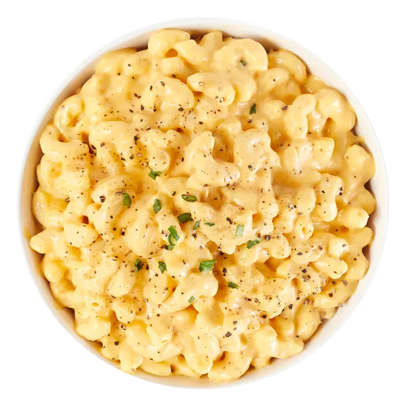 Bowl of creamy macaroni and cheese, sprinkled with pepper and chives.