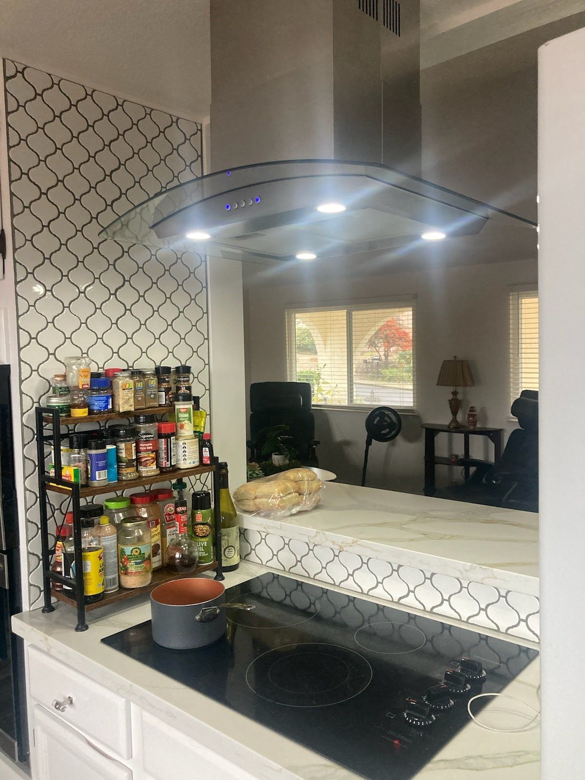 A kitchen with a stove top oven and a pot on it