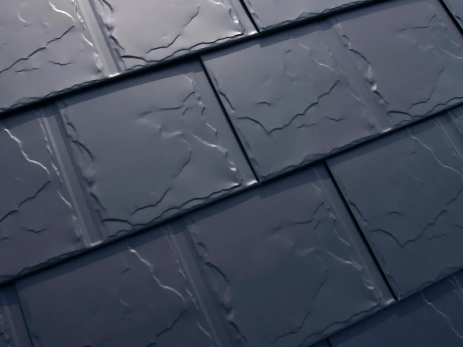 Interlock Slate aluminum metal roof panels in dark charcoal, close-up slate texture, Portland, Oregon.