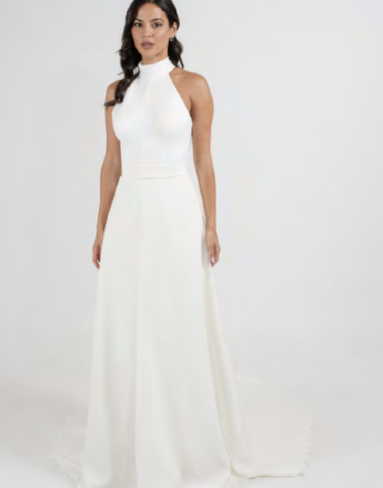 A woman is wearing a white dress with a halter neckline.