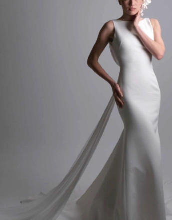 A woman in a white dress with a long train