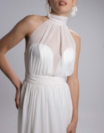 A woman in a white dress with a halter neckline