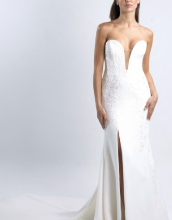 A woman in a white wedding dress with a plunging neckline