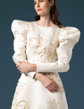 A woman in a white dress with puffed sleeves