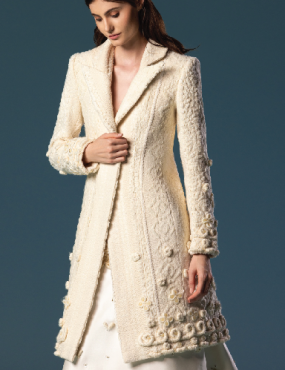 A woman wearing a white coat and a white dress