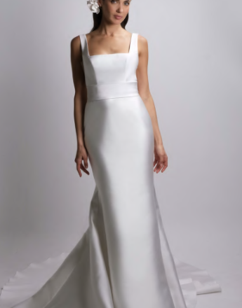 A woman in a white wedding dress with a flower in her hair