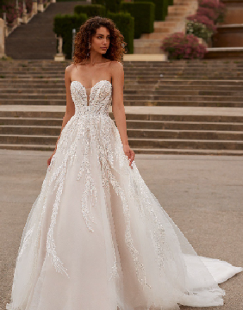 A woman in a wedding dress is standing in front of a set of stairs.